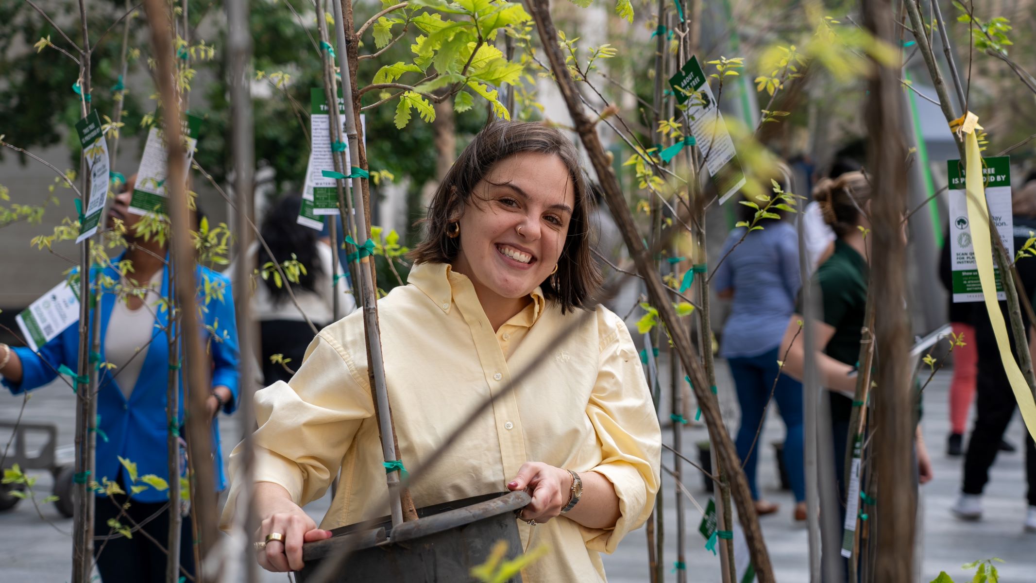 Employee with tree at ewaste event